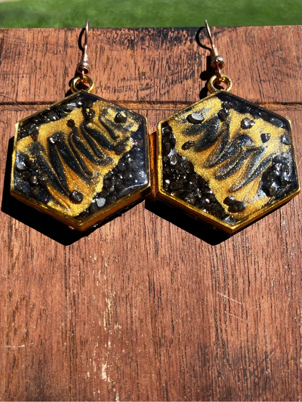 Black and gold hexagon dangle earrings with rock accents